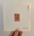 A needlepoint canvas featuring an ACOTAR book cover pattern. The cover has been miniaturized so the "text" is indiscernible as actual words but still recognizable to the iconic red and yellow cover. The canvas features a color palette panel and is signed by "Eloise."