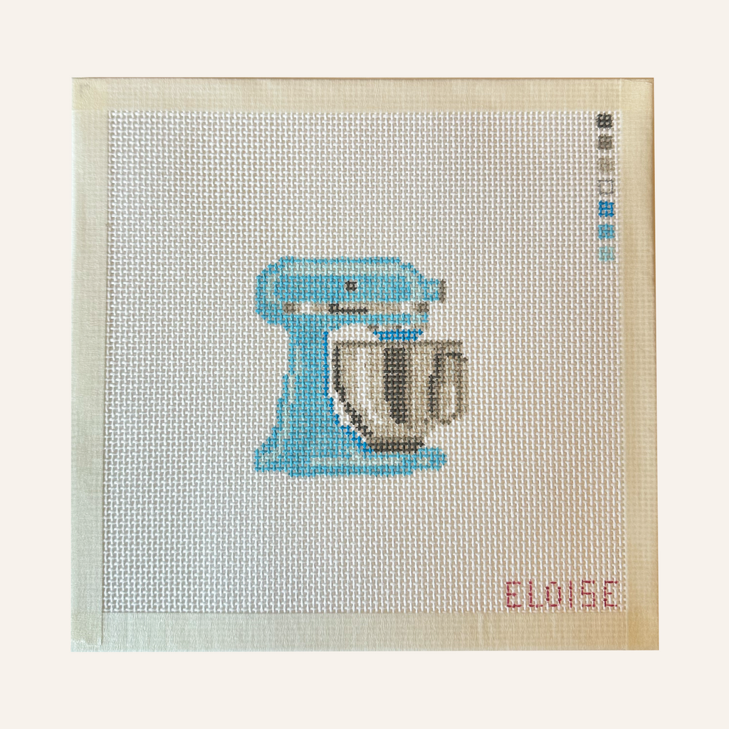 needlepoint canvases featuring a stand mixer pattern in blue. The canvases feature a color palette panel and is signed by "Eloise."
