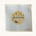 A Hufflepuff needlepoint canvas designed as a red circle with Hufflepuff motifs. the canvas has a color palette guide and is signed "Eloise"